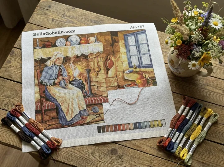 An elderly woman is sewing.