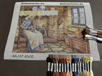 An elderly woman is sewing.